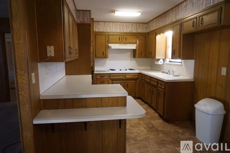A kitchen with wooden cabinets and a white countertop.