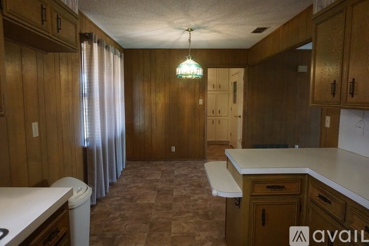 A kitchen with wooden cabinets and a white countertop.