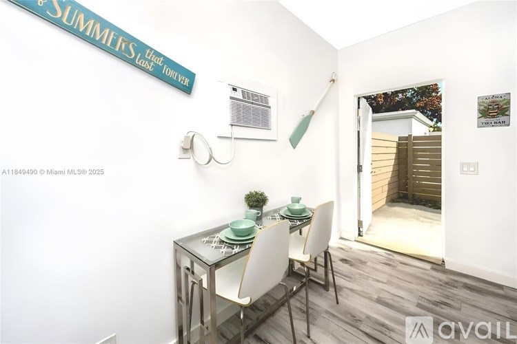 A dining area with a glass table and white chairs.
