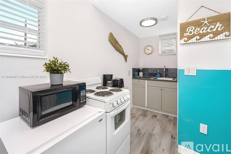 A kitchen with a white countertop and a white stove.