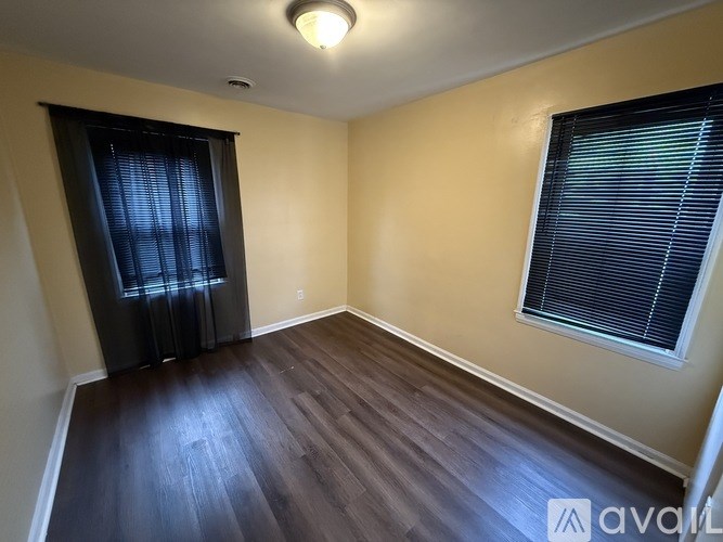 A room with a window and a door.