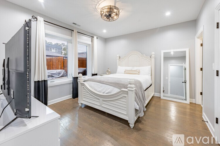 A bedroom with a large bed and a television.
