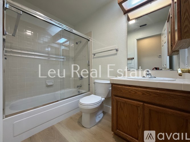A bathroom with a toilet, sink, and bathtub.