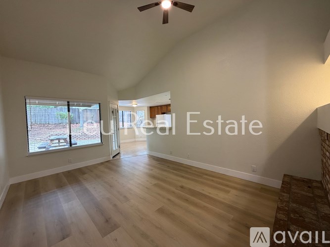 A room with wooden flooring and a ceiling fan.