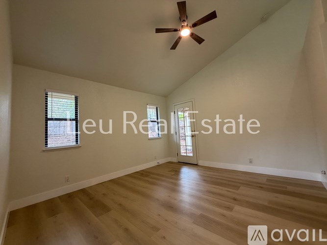 A room with a ceiling fan and wooden flooring is available for rent.