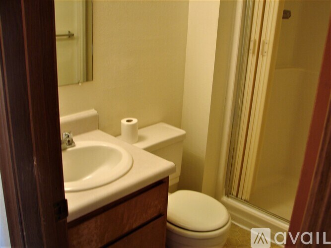 A white toilet sits next to a sink in a bathroom.