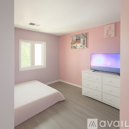 A bedroom with a bed, dresser, and television.
