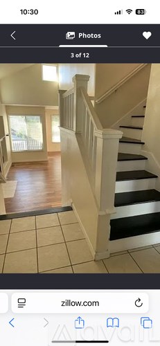 A staircase with white railings and black steps.