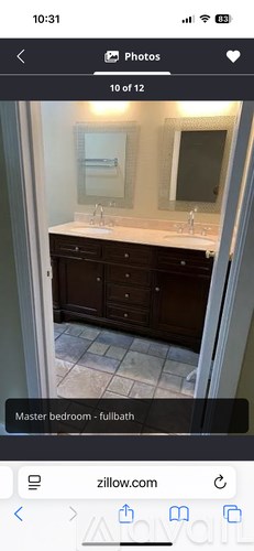 A bathroom with a sink, mirror, and cabinet.