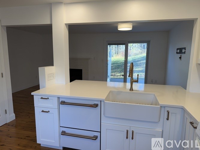 A kitchen with white cabinets and a sink.