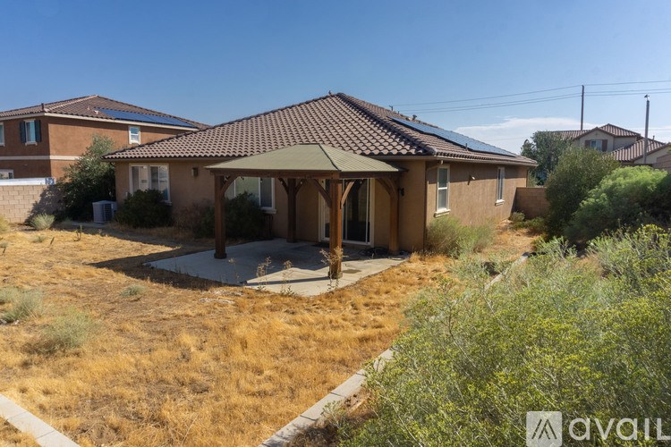 A house with a brown roof and a covered patio area.