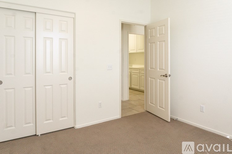 A room with two doors, one of which is open.