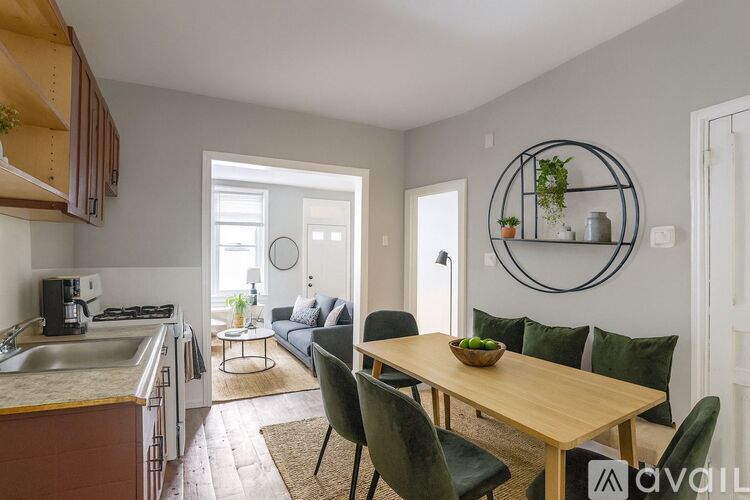 A kitchen with a dining table and chairs in the foreground.