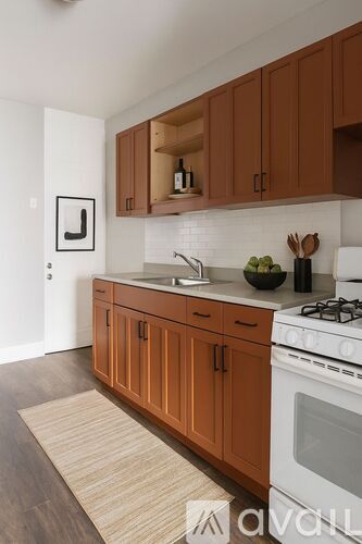 A kitchen with wooden cabinets and a white stove.