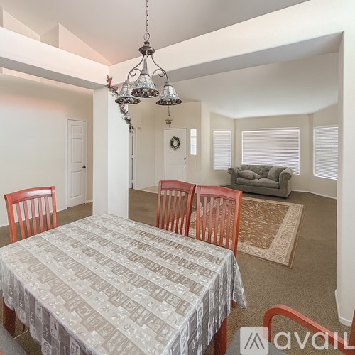 A dining room with a table and chairs.