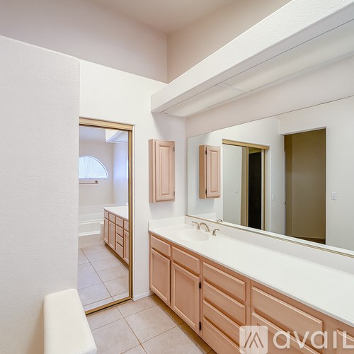 A bathroom with a vanity and a mirror.