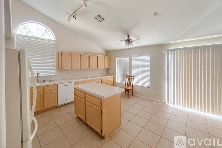 A kitchen with wooden cabinets and a white fridge.