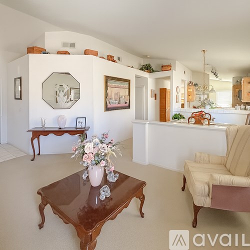 A living room with a brown coffee table and a beige sofa.