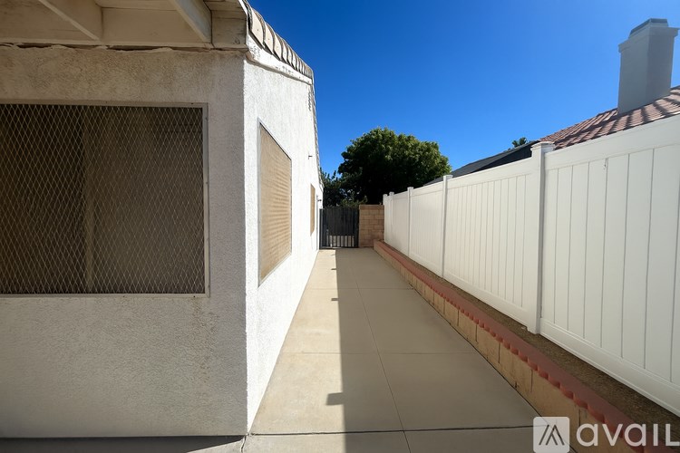 A white building with a closed window and a closed door.