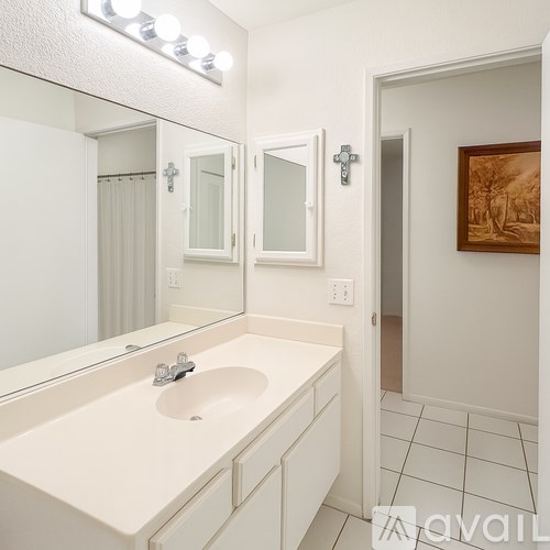 A bathroom with a sink and mirror.