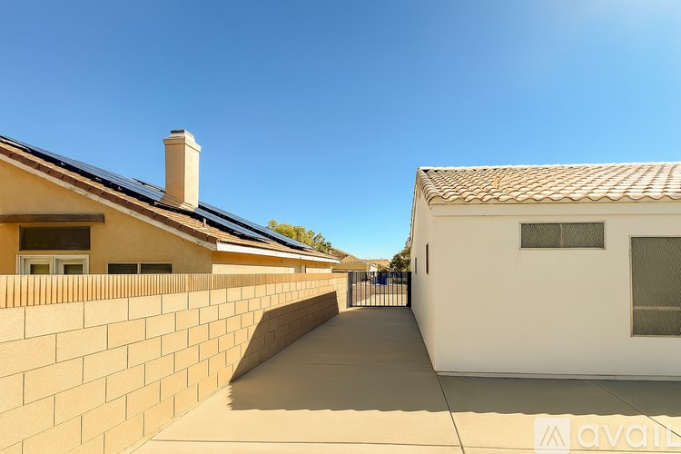 A row of houses with a clear blue sky above them.