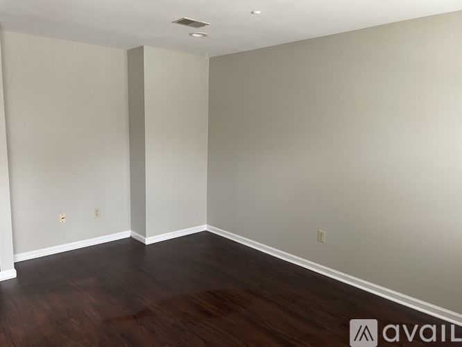 A room with wooden floors and white walls.