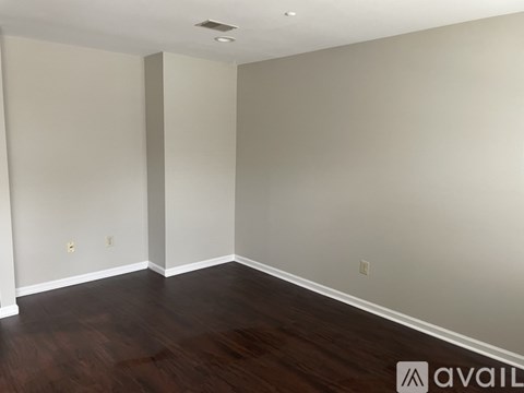 A room with wooden floors and white walls.