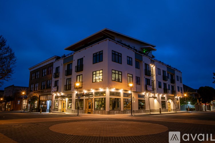 A large, well-lit building with a circular courtyard in front.