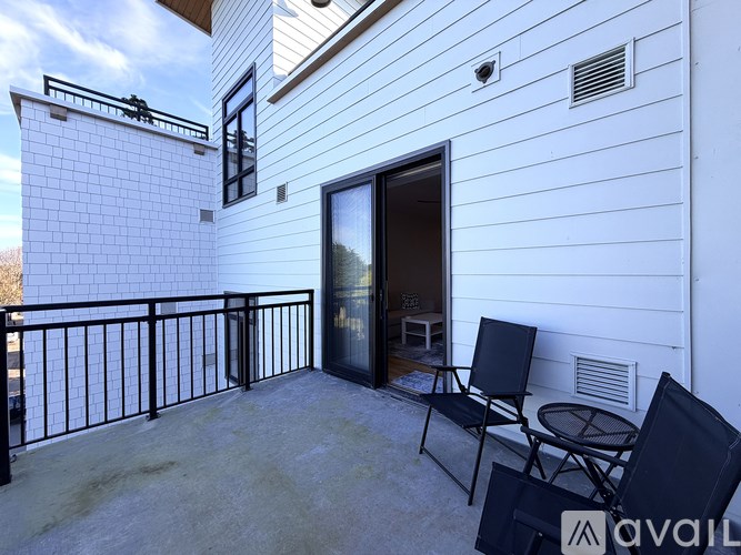 A balcony with a table and chairs is shown.