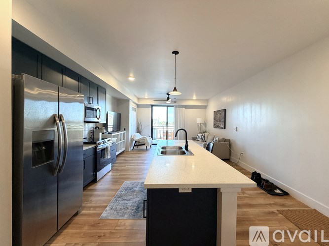 A modern kitchen with a large island and stainless steel appliances.