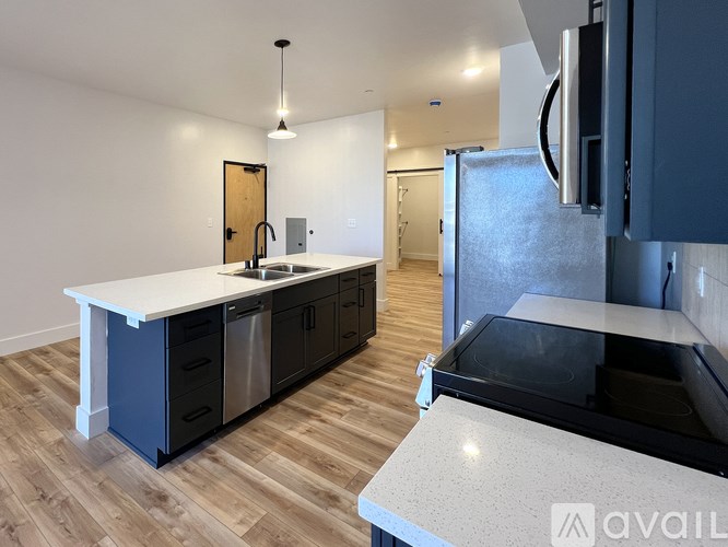 A kitchen with a white countertop and dark cabinets.