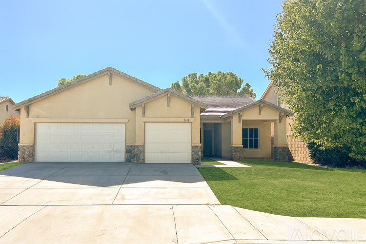 A tan house with a white garage door.