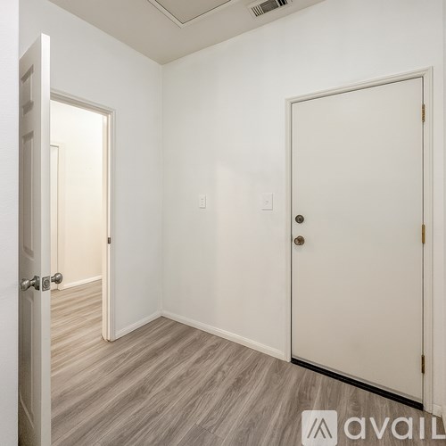 A room with two doors and a window.