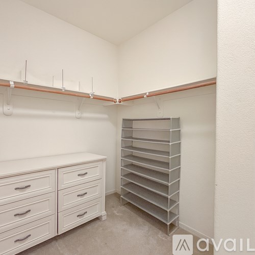A white closet with drawers and shelves.