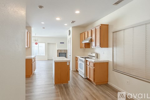 A kitchen with wooden cabinets and a white countertop.