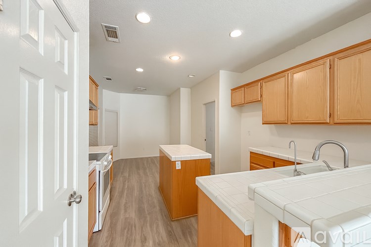 A kitchen with wooden cabinets and a white countertop.