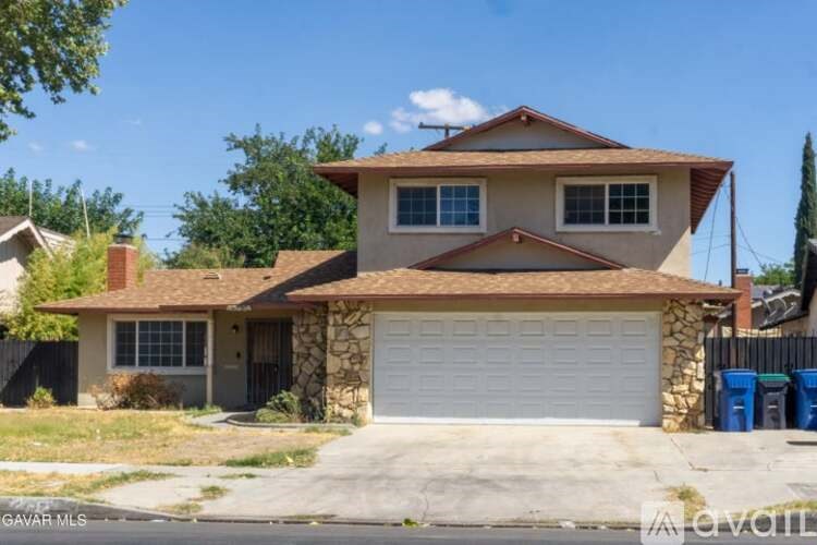 A two-story house with a garage is for sale.