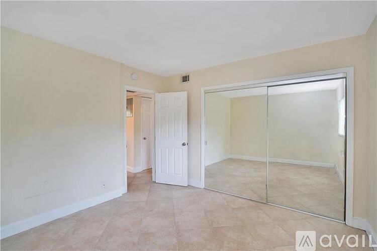 A room with a white door and a glass wall.