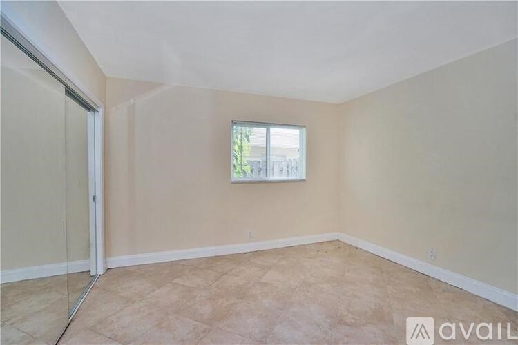 A room with a window and a sliding glass door.