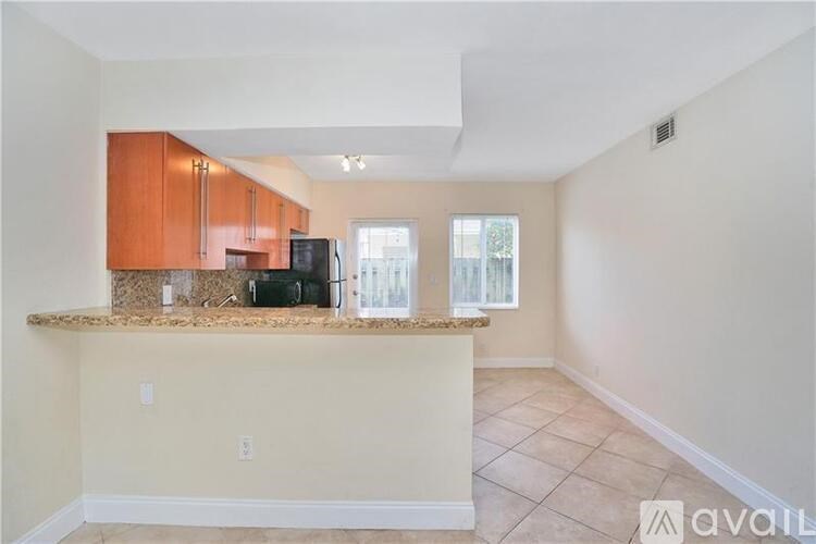 A kitchen area with a counter and cabinets.