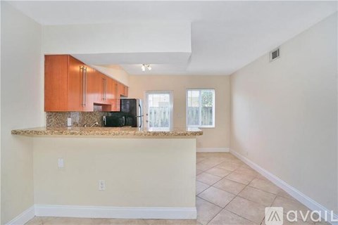 A kitchen area with a counter and cabinets.