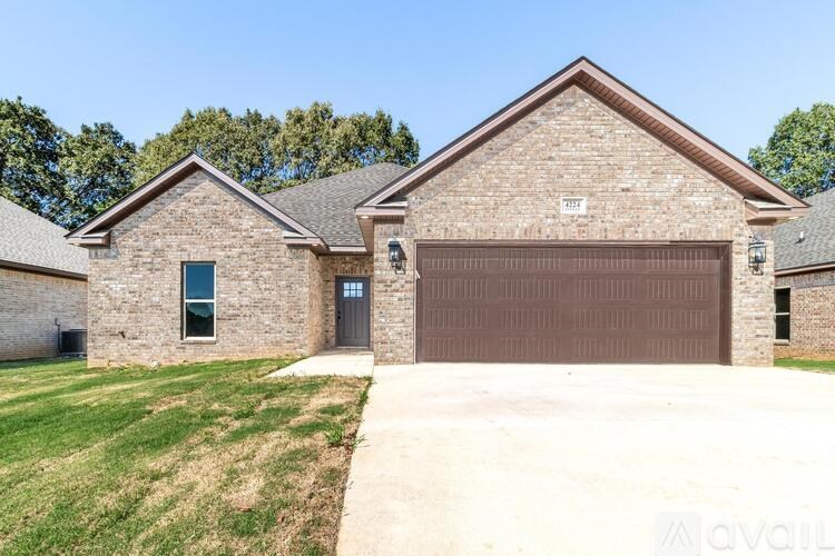 A two-story house with a garage door and a driveway.