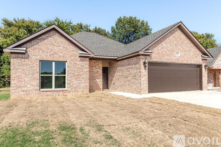 A brick house with a garage door and a window.