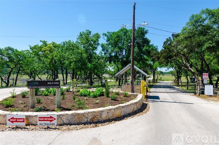 A sign at the entrance of a park indicates that boats are not allowed.