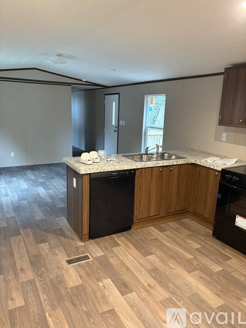 A kitchen with wooden cabinets and a marble countertop.