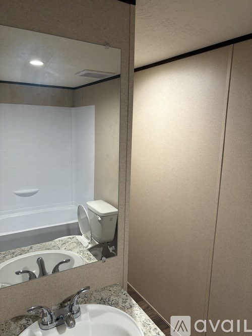 A bathroom with a sink, mirror, and toiletries.