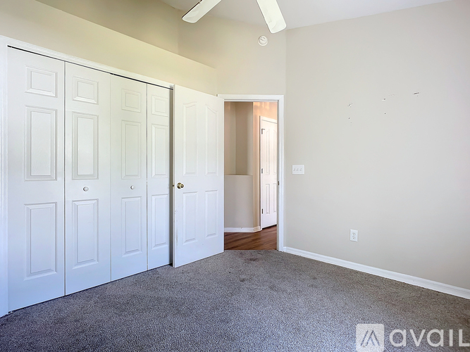 A room with white doors and a carpeted floor.