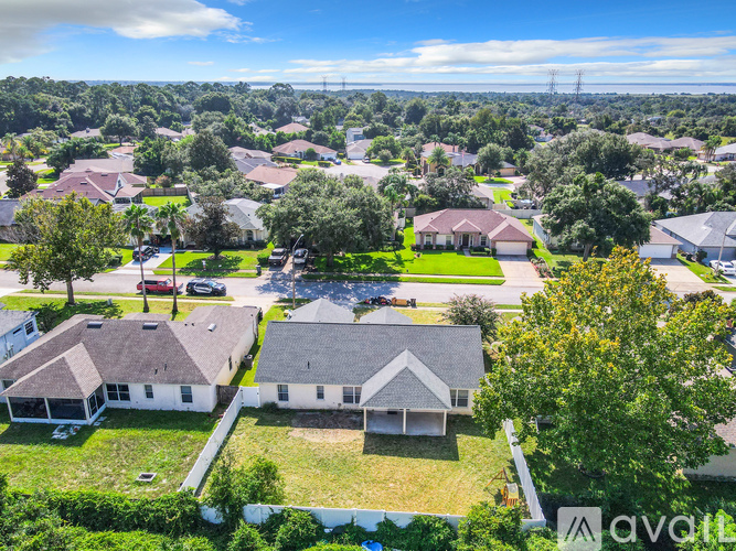 A bird's eye view of a residential neighborhood with houses and trees.