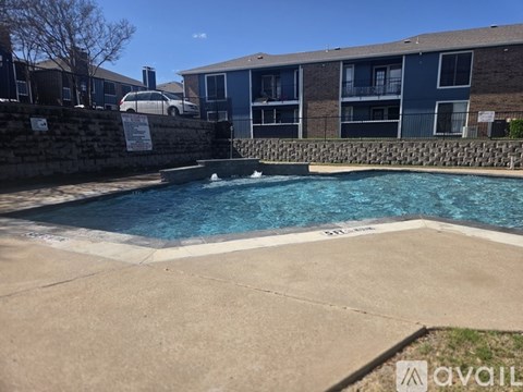 A small pool in a courtyard surrounded by a stone wall.