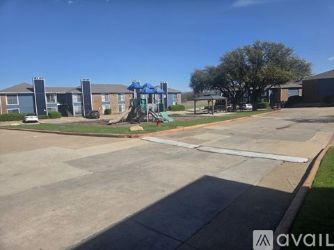A sunny day at the playground in front of apartment buildings.